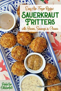 some fried food on a blue and white plate with dipping sauces in small bowls