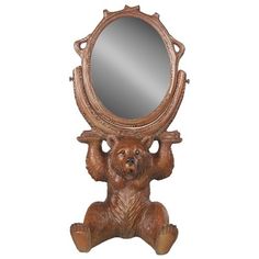 a wooden bear holding up a mirror on its hind legs with it's paws in the air