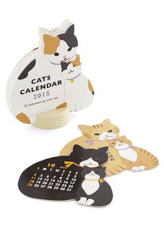 three magnets with cats on them sitting next to each other in front of a white background