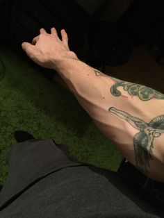 a man's arm with tattoos on it