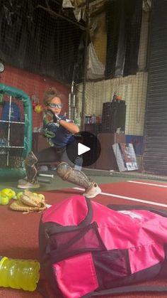 a young boy is practicing his baseball skills