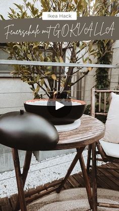 an outdoor table with two chairs and a potted tree in the background that reads, fuschia and go kalla