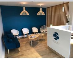 an office with blue walls and white chairs