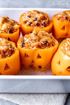 stuffed bell peppers in a white baking dish