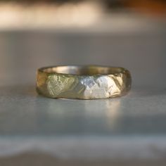 a close up of a wedding ring on the ground with no one in it's photo