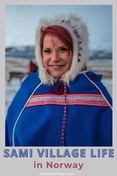 a woman with red hair wearing a blue jacket and white fur hat smiling at the camera