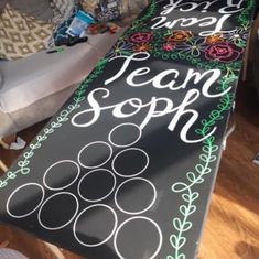 a long chalkboard with the words team soph painted on it