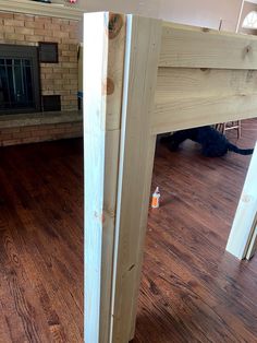 a room with wood floors and a brick fireplace