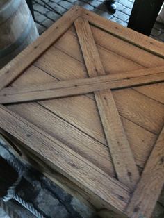 a wooden table sitting on top of a brick floor