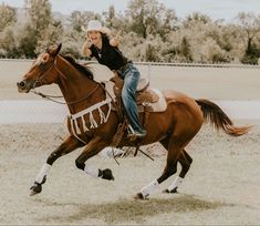 a woman riding on the back of a brown horse