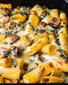 a casserole dish filled with pasta and spinach