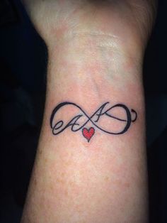 a wrist tattoo with an infinite love symbol