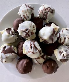 a white plate topped with chocolate covered donuts