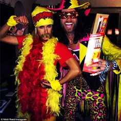 two people dressed up in costumes posing for a photo with one person holding a book