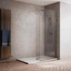 a bathroom with a walk in shower next to a towel rack