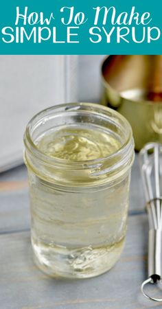 a jar filled with homemade simple syrup next to a whisk and measuring spoon