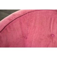 the back of a pink chair with buttons on it