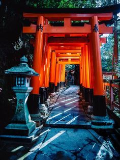 an orange gate with lanterns on each side