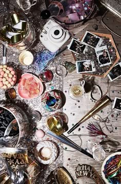 a table topped with lots of different types of plates and bowls filled with confetti