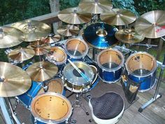 a blue drum set sitting on top of a wooden deck