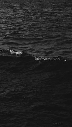 a person riding a surfboard on top of a wave in the middle of the ocean