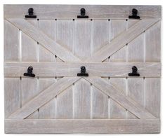 an old wooden barn door with black hardware and latches on the doors, isolated against a white background