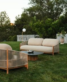 a couch and table sitting in the grass