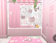 a bathroom decorated in pink and white with hello kitty rugs