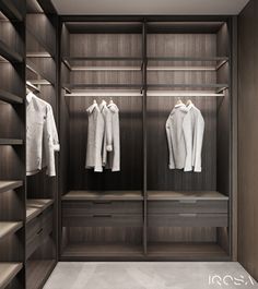 an empty walk in closet with clothes hanging on shelves