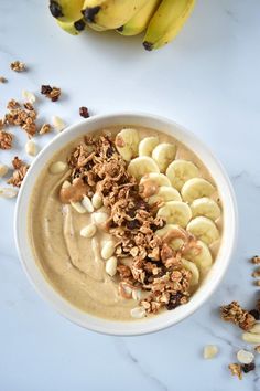 a bowl filled with oatmeal and nuts on top of a white table