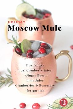 two moscow mules with cranberries and rosemary for garnish