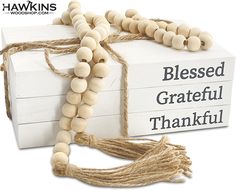 a wooden bead necklace on top of a box with the words, blessing grateful thank