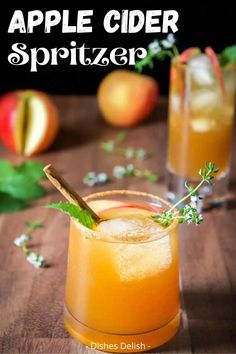 an apple cider spritzer is garnished with mint