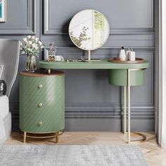 a dressing table with a mirror and vase on it in front of a gray wall