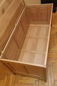 an empty wooden chest sitting on the floor