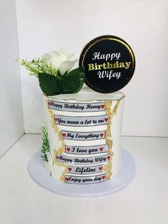 a happy birthday cake with white flowers in it