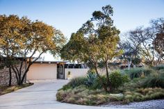 a house with trees and bushes around it