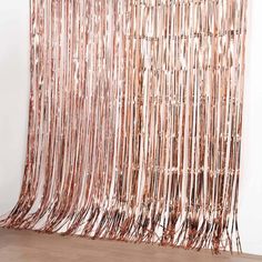 the curtain is made out of copper foil and has fringes hanging from it's sides