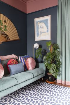 a living room filled with furniture and a fan hanging above it's headboard