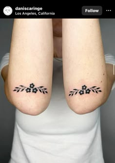 two women with matching tattoos on their arms