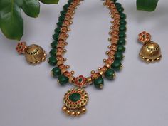 This Aadarshini Terracotta Grand Jewelry set is a must-have for any fashion-forward individual. Handcrafted from high-quality terracotta, this set boasts intricate designs and vibrant colors that are sure to make a statement. Perfect for any occasion, add a touch of elegance and culture to your wardrobe with this unique jewelry set. *Specifications*:- Category : Grand Jewelry Set Sub-Category : Terracotta Jewelry set Style : Traditional Indian Wear Earring Type : Stud with Jhumka Material: Terra Green Temple Jewelry Sets For Festive Occasions, Festive Green Temple Jewelry Sets, Indian Jewelry Traditional, Jewelry Traditional, Traditional Necklace, Traditional Indian Jewellery, Terracotta Jewellery, Set Style, Earring Type