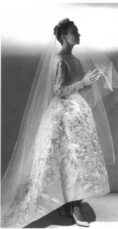 an old photo of a woman in a wedding dress with a veil over her head