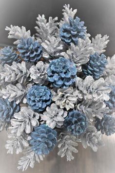 a bunch of blue and silver pine cones