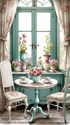 a table and chairs in front of a window filled with potted flowers on it