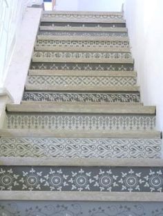 the stairs are decorated with intricate designs on them and painted in blue, white, and grey