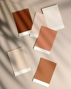 four different shades of brown and white on a wall