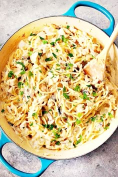 a blue skillet filled with pasta and chicken