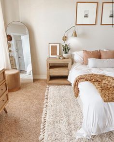 a bedroom with a bed, dresser and mirror on the wall next to each other