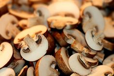 many mushrooms are shown together in this close up photo, including one with the letter e on it