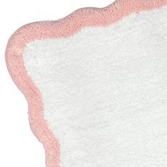 a pink and white area rug on a white background